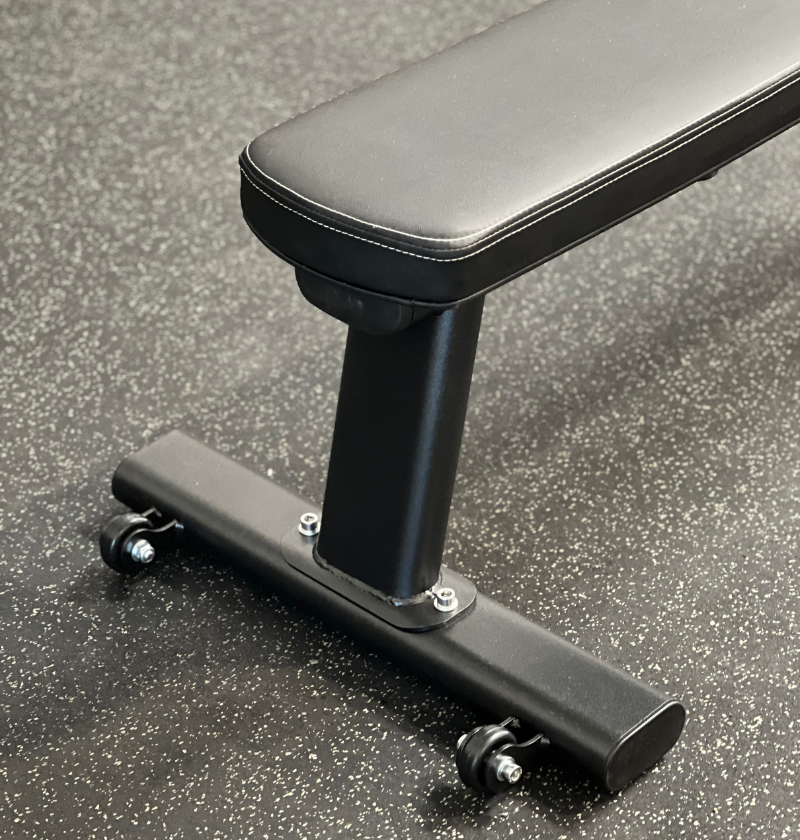 A black gym bench featuring a sleek black seat and wheels