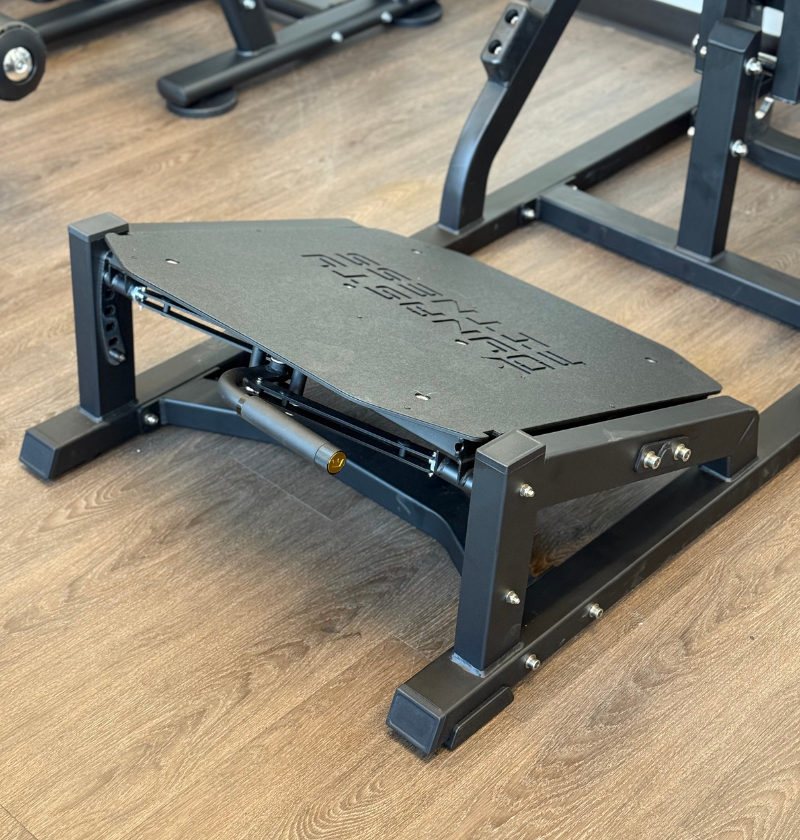 Front squat foot plate on a wood floor.