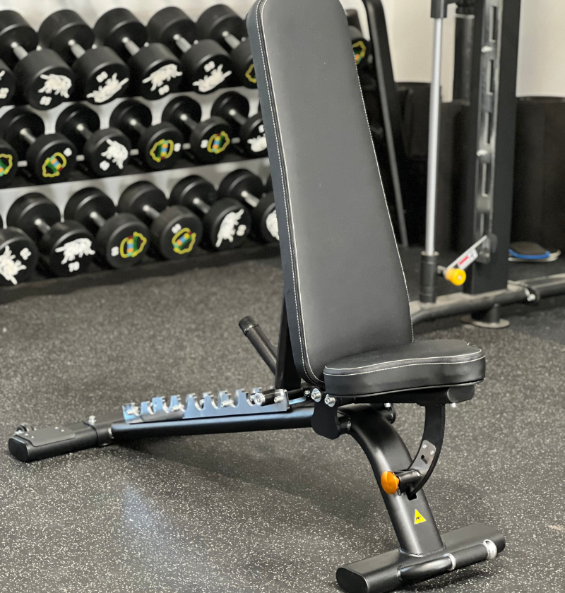 Adjustable Flat Incline Bench PL7328 displayed in a gym setting.