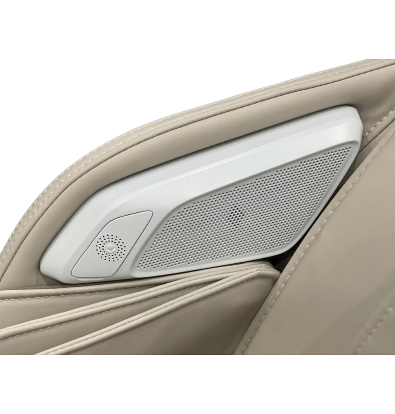 A massage chair with a speaker located at the center of the seat back, providing immersive sound while seated.