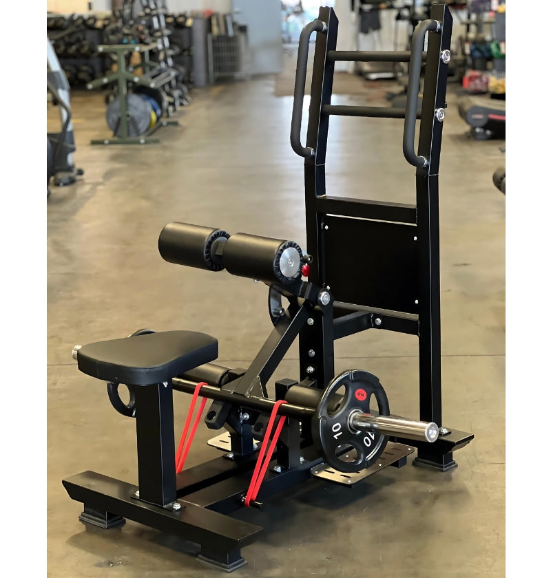 A leg press machine located in the middle of a gym, adjacent to the standing hip thrust workout area.