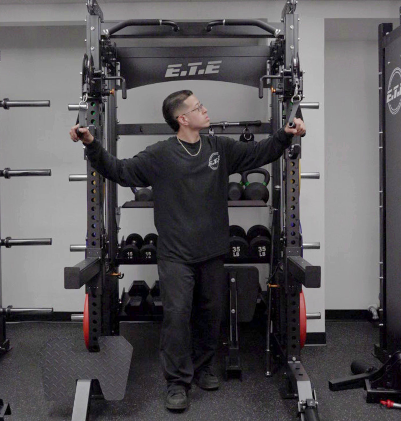 Person using a power rack in a gym setting