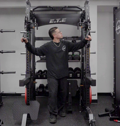 Person using a power rack in a gym setting