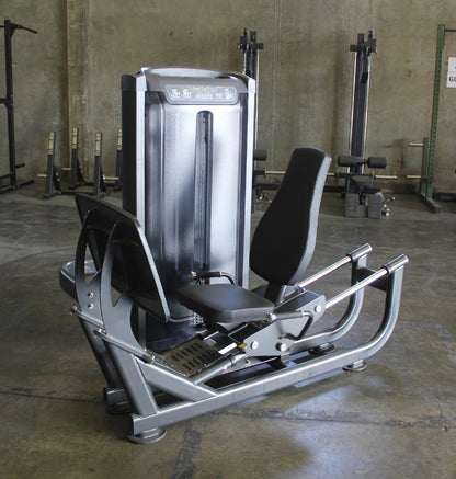 seated leg press machine in a warehouse