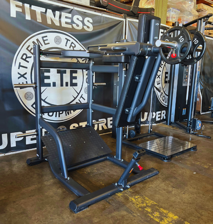 A gym setup featuring a pendulum squat machine, complete with a squat rack and bench for workout sessions
