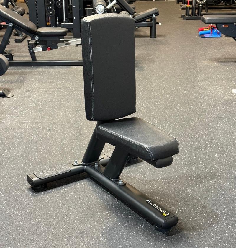 Black tricep seat on a speckled rubber floor