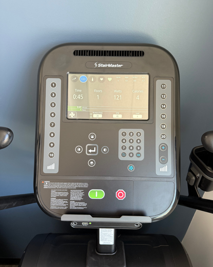 Control panel of a StairMaster exercise machine with digital display and buttons.