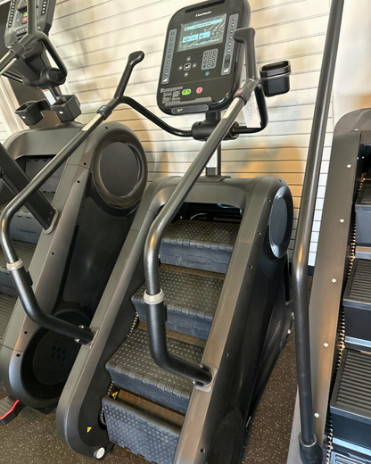 Stair climber machine in a gym setting with digital display