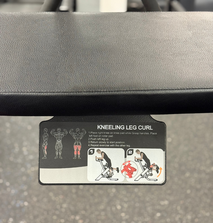 Instructions for a kneeling leg curl exercise on a gym machine.