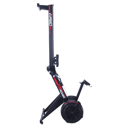 Commercial AirGo Rower rowing machine with black and red color scheme, featuring a thick padded seat, console with various function buttons, and air resistance mechanism.