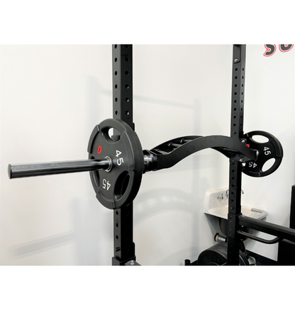 A black barbell, labeled as extreme cambered multi grip bar mounted securely on a wall, designed for weightlifting and strength training exercises.
