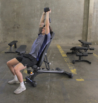 A man is exercising on the Adjustable Flat Incline Bench ELITE PL7328B, showcasing a fitness routine for strength training.